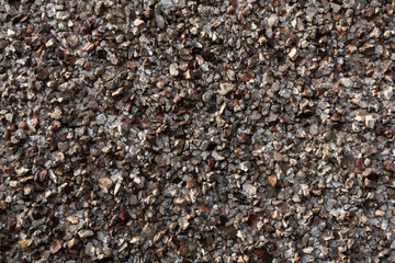 Pebble dash wall showing a textured surface made from small stones and concrete © Pavlo