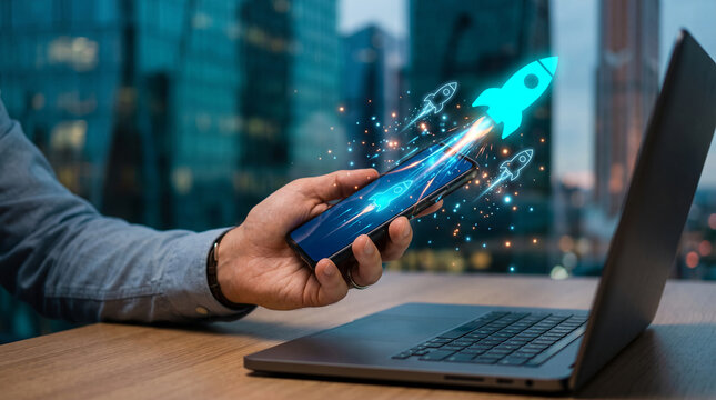 Hand holding smartphone with glowing rockets launching, representing business growth and startup success on a city background