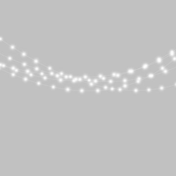 Strings of soft glowing white lights hang delicately against a deep black background. The bulbs are evenly spaced along curving thin wires with a luminous halo effect.
