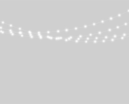 A series of softly glowing white string lights hang against a pitch-black background. The lights are arranged in three parallel curved lines with evenly spaced luminous bulbs.