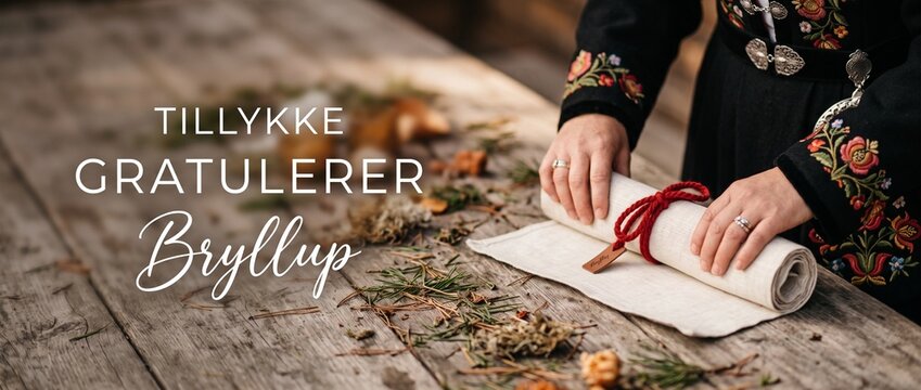 Norwegian wedding congratulations greeting card text, hands rolling scroll in traditional Bunad attire, rustic wooden table Scandinavian Nordic culture ceremony celebration Tillykke Gratulerer Bryllup