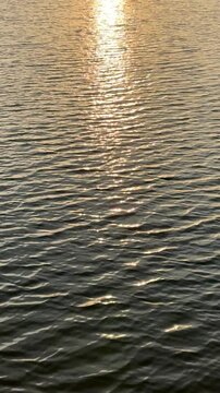 sunlight reflecting on the water at sunset