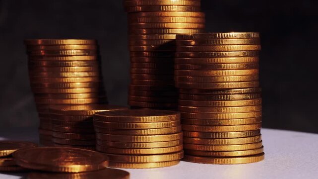 Rising stacks of gold coins representing financial growth, savings, and investment concept