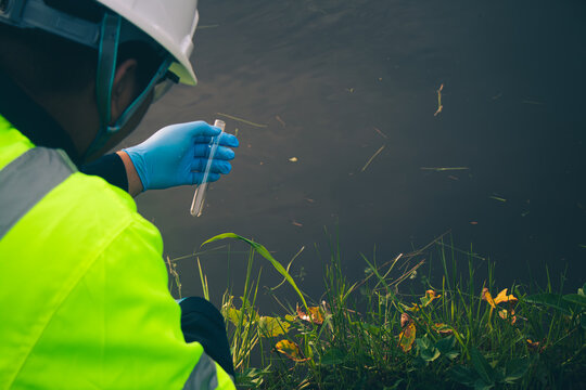 Officials conducting water quality inspection by collecting samples for contamination analysis.