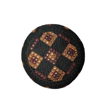 Black Muslim skullcap for Islamic prayer isolated on white background, traditional religious headwear representing faith, worship, spirituality and cultural heritage.