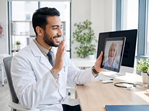 Male Doctor Video Calling Elderly Patient on Tablet in Modern Office