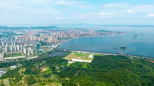 Aerial view of the cityscape and large lake in Jiujiang city located in Jiangxi province of China showing urban development and natural landscape