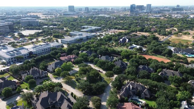 Luxury custom homes nestle among dense mature trees bordering HALL Park in Greater Dallas area. Corporate lowrise offices overlook wooded neighborhoods throughout vibrant Frisco, Texas