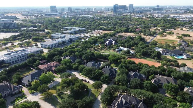 Expansive residential properties blend into wooded greenbelts along Dallas Fort Worth metroplex. Corporate office parks border private luxury homes across scenic outskirts, Frisco, Texas