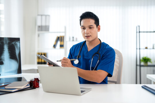 Doctor looking at laptop screen writing in notebook for research planning or medical tech innovation in hospital office. Healthcare medic worker, research strategy book notes and online communication.