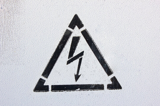 Warning sign risk of electric shock. Text indicating a warning about electrical voltage and electric current, wallpaper