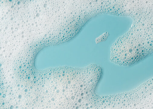 Closeup soapy foam with turquoise water pool and concentrated bubbles, with foam, bubble, soap, soapy detail, showing turquoise,