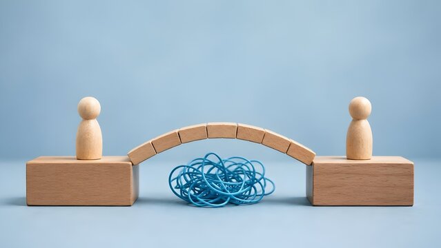 Wooden bridge connecting two figures over a tangled blue wire representing problem solving and overcoming complex business challenges
