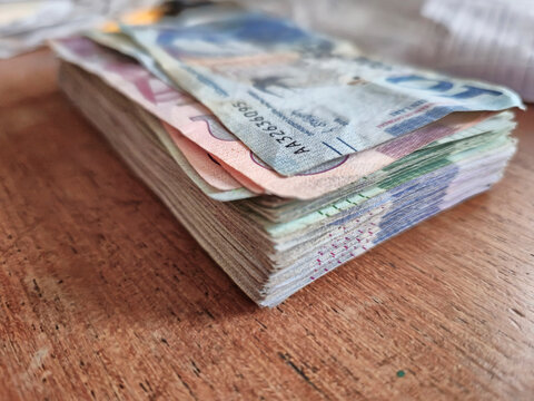 Stack of Multicolored Banknotes on Wooden Surface