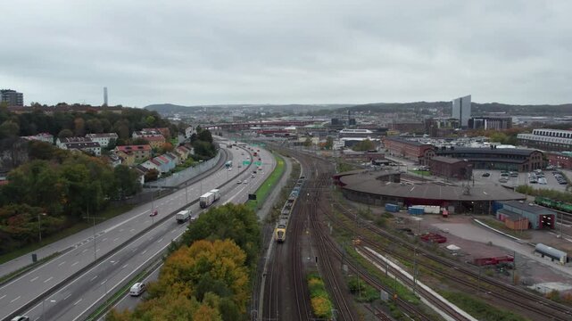 Commuter train passing by Savenas in Gothenburg, Sweden. Aerial Tilt Up