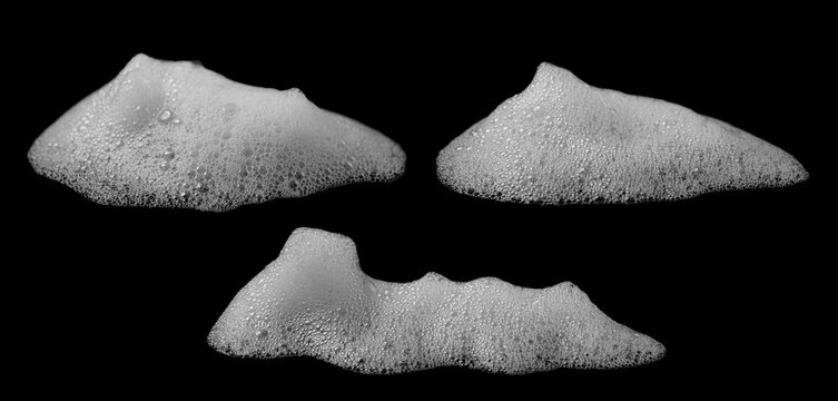 White soap foam bubbles isolated on a black background, featuring detailed frothy texture and organic shapes, ideal for cleaning, hygiene, beauty, product advertising, packaging, and creative design.