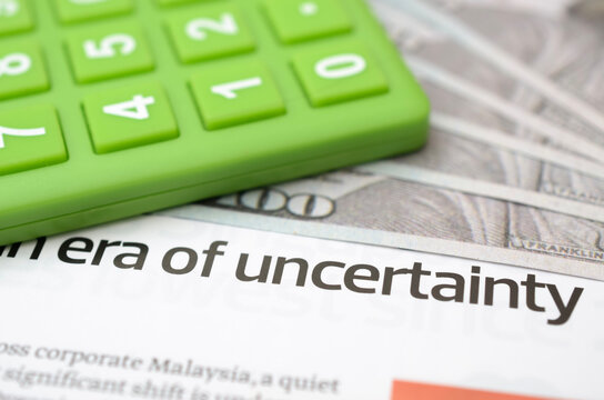 Financial Uncertainty Concept with Calculator, Cash and Economic News