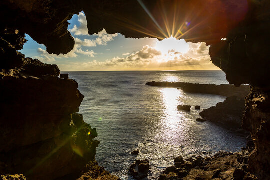View of Ana Kakenga, a volcanic cave with two natural openings overlooking the Pacific Ocean at sunset, Easter Island, Valparaiso, Chile.