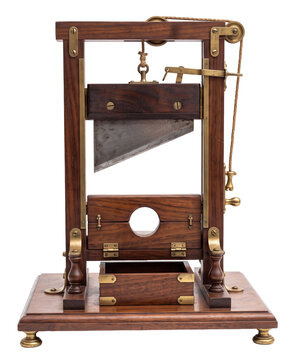 wooden antique guillotine execution device with sharp angled metal blade on a transparent background