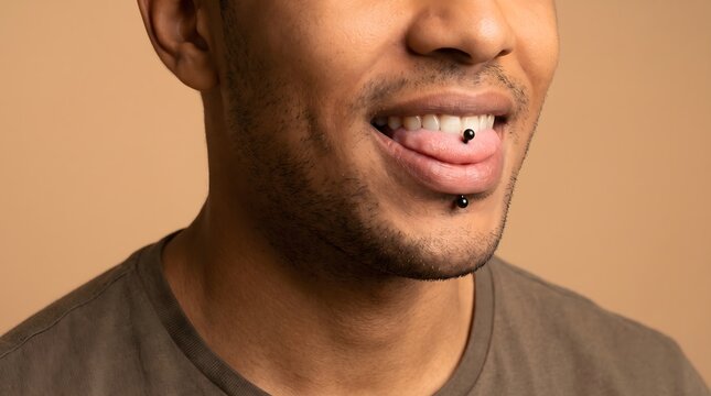 Man Showing Tongue and Lower Lip Piercings