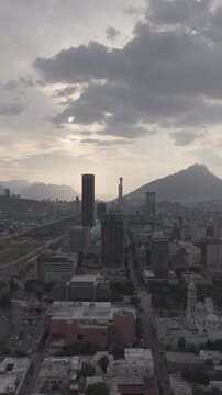 Aerial ascending view over downtown Monterrey revealing the Macroplaza, Palacio de Gobierno and skyline during golden hour, Nuevo Le&oacute;n. Vertical video. D-Log M