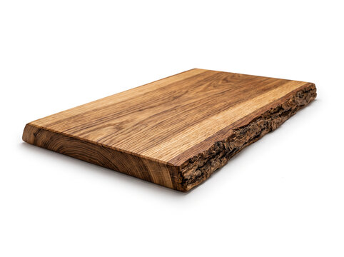 A wooden serving board seen low at 20 degrees, live-edge oak, rich grain texture, isolated on white background.