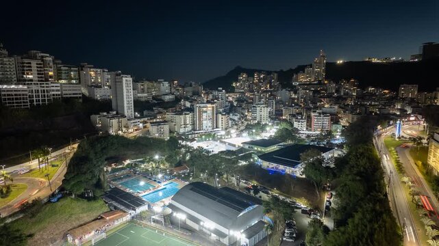 Night Timelapse Over Residential Towers and Glowing Blue Pools