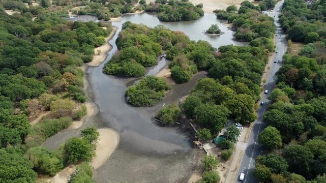An aerial view of a lake dried up is surrounded by cracked earth exposed by heat wave and drought conditions.