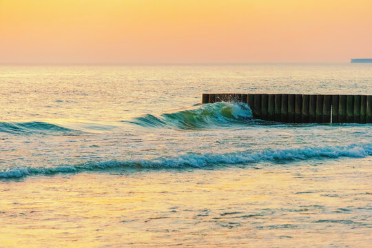 Sunset twilight over sea wooden breakwater
