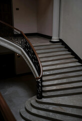 Obraz premium Luxury architecture and interior design, grand marble staircase with ornate wrought iron railing in a classic historic building hallway