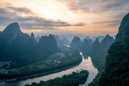 Panoramic sunset view of the Li River flowing through karst mountains in rural Guilin China