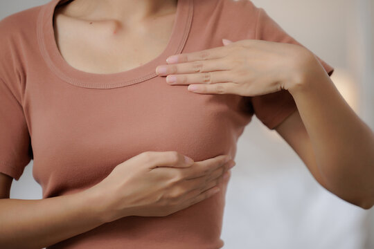 Woman checking her breast with hands at home, breast self examination, health awareness, early detection, healthcare, prevention, screening, Breast cancer, chest pain.