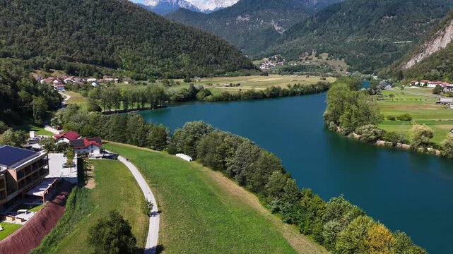 Aerial view of Most na Soci with the Soca River, Santa Lucia, Slovenia. Canoes, SUPs, and swimmers in the water.