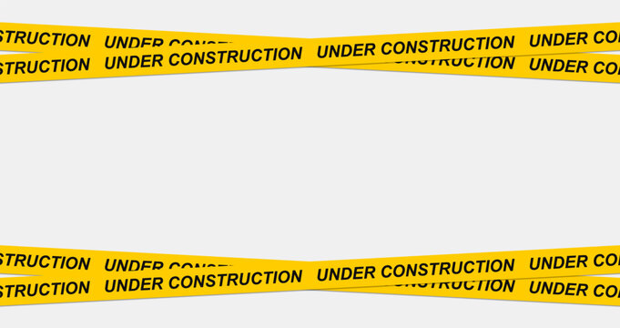 Yellow and black caution tape with the words under construction repeats across a light gray background barrier warning