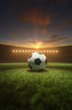 Soccer ball in a stadium in the sunset