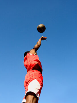 Player Shoots Basketball Against Clear Blue Sky
