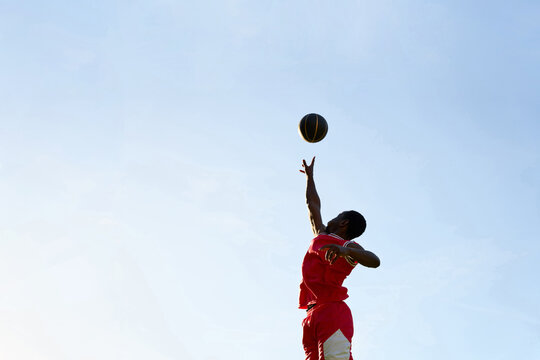 Young Athlete Jumps High to Make a Basketball Shot During Practice
