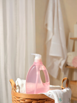 Pink liquid detergent bottle with dispenser in a woven basket