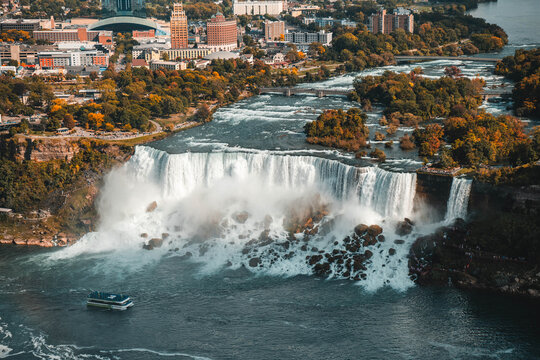 Niagara Falls waterfall cascading over rocky cliff edge with powerful flowing water motion