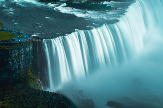 Niagara Falls waterfall cascading over rocky cliff edge with powerful flowing water motion