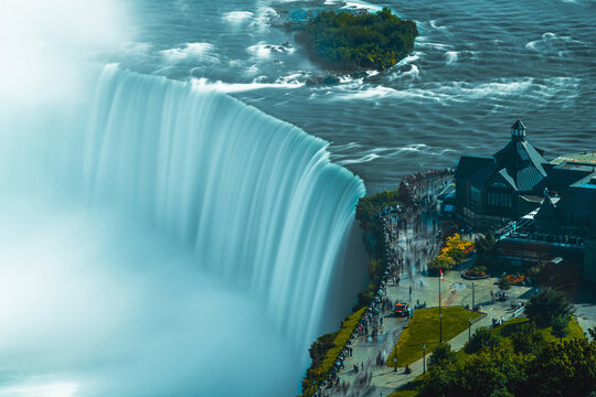 Niagara Falls waterfall cascading over rocky cliff edge with powerful flowing water motion