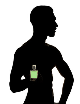 A profile shot of a muscular, shirtless male model standing in deep shadow.
