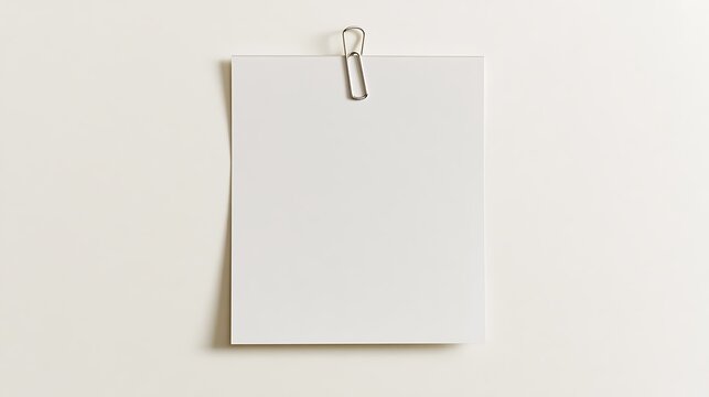 Minimalist paper sheet hanging from a simple metal binder clip