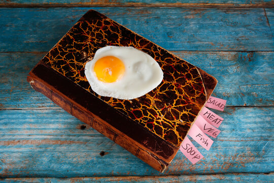 vintage cookbook and a fried egg, cooking, food and drink, education, breakfast, kitchen,