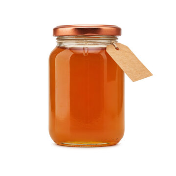 Glass jar of golden honey with a blank rustic paper tag isolated on transparent background
