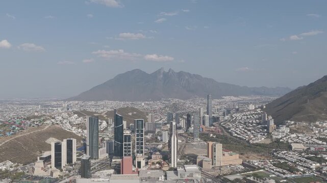 Aerial panoramic hovering shot of the San Pedro Garza Garc&iacute;a skyline with the Cerro de la Silla in the background, Monterrey, Nuevo Le&oacute;n. D-Log M