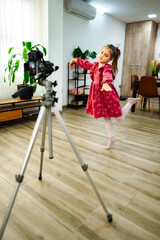 Little girl dancing ballet in front of camera at home © Jelena