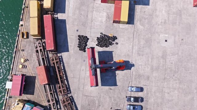 Container Terminal Operations at Port with Heavy Reach Stacker Moving Cargo Containers. Aerial View of Container Terminal with Reach Stacker Moving Shipping Containers