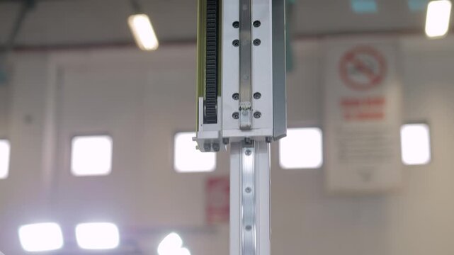 Automatic pick and place robotic arm manipulator with suction cups and lowers white polypropylene yogurt containers: plastic injection molding machine at exhibition, plant - close up