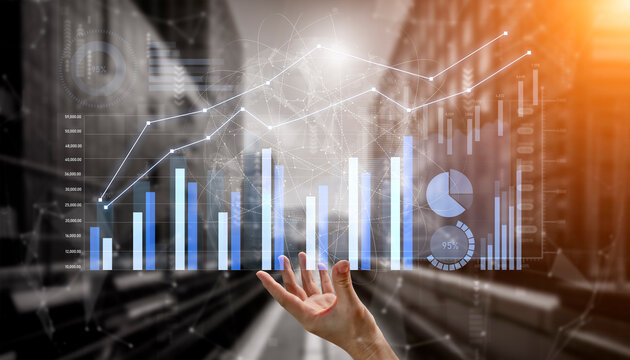 A person reaching out towards vibrant digital graphs and data visualization in a modern business setting, symbolizing financial growth and informed decision-making. Scalp